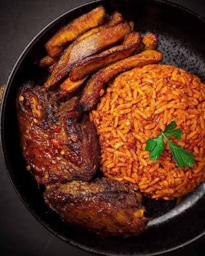 Nigerian jollof rice served with chicken and plantains